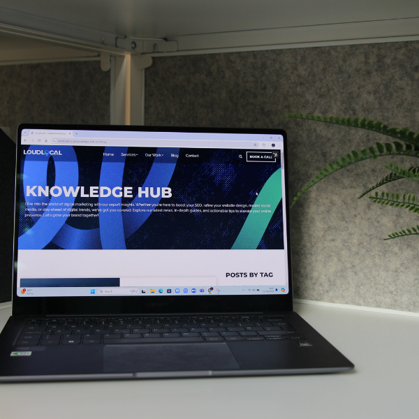 A picture of one of our laptops displaying our knowledge hub page from our website.