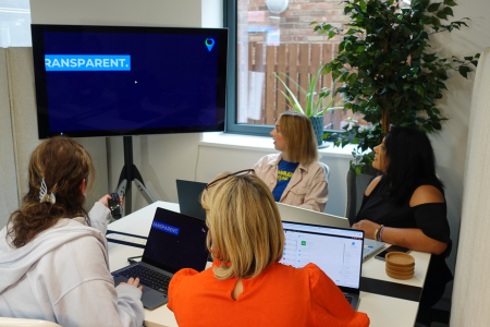 3 of the LoudLocal team talking a client through a presentation in the conference room