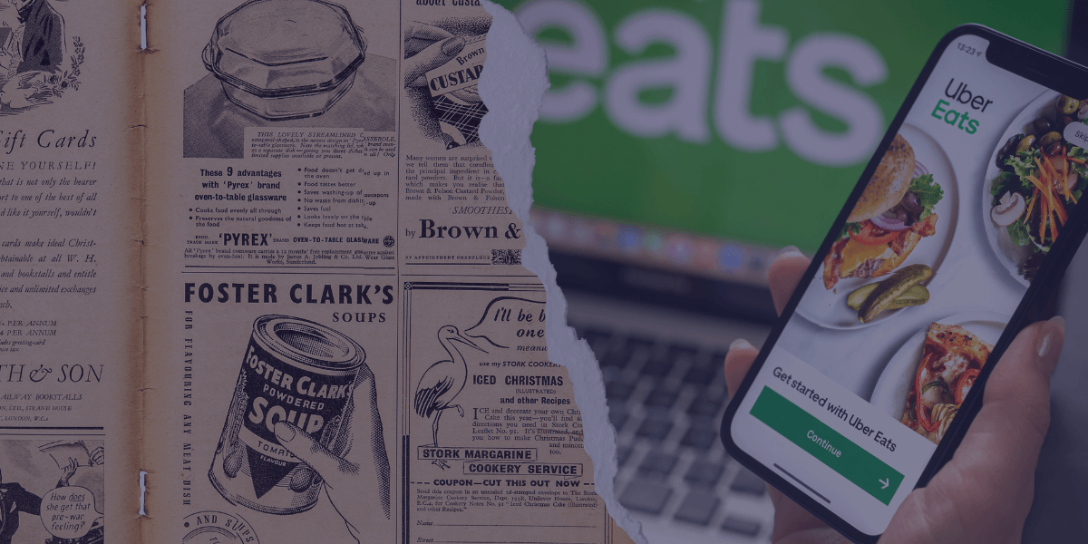 A photo of an old advert from a newspaper advertising Foster Clark's Soup in focus and series of other foods. On the right is somebody holding a phone over a laptop, both devices displaying UberEats to display how digital advertising is now. Separating the images is a paper tear.